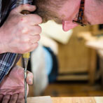 Ben Casson making a shelving unit in his workshop at Wobage Farm 2016